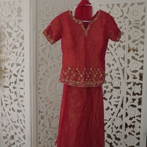 Red Indian outfit (lehenga) with gold bead work.